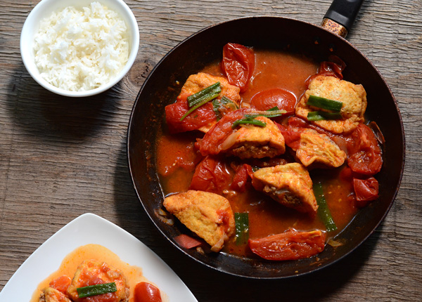 Close-up of fried, pork-stuffed tofu in a tomato sauce (Vietnamese Đậu Hũ Dồn Thịt Sốt Cà Chua) | HungryHuy.com