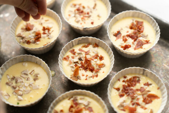 adding toppings to the top of egg muffins