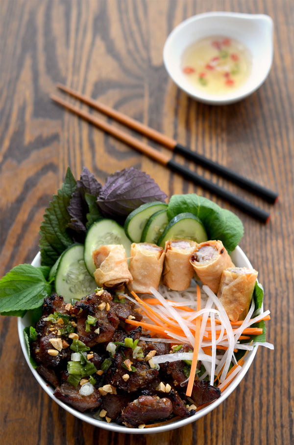 A bowl of Vietnamese grilled pork with vermicelli noodles, eggrolls with fresh and pickled veggies (bun thit nuong) | HungryHuy.com