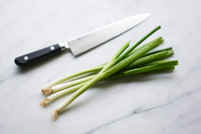 green onions and a chefs knife