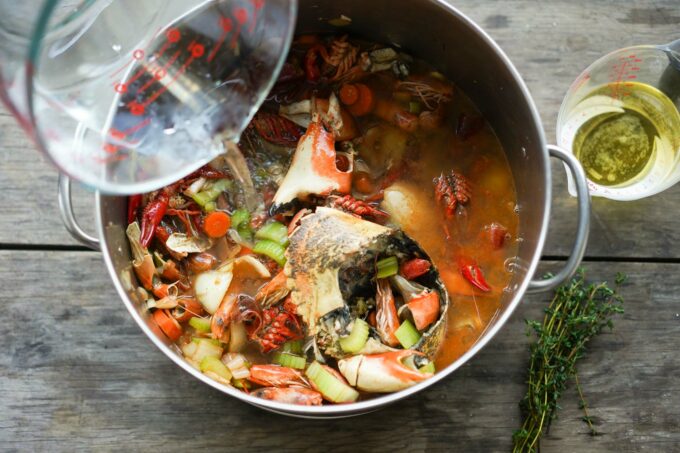 pouring water into pot for seafood stock
