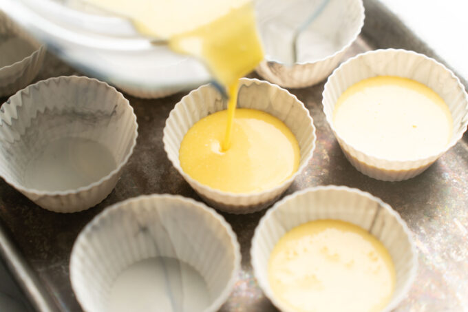 pouring egg mixture into silicone baking cups